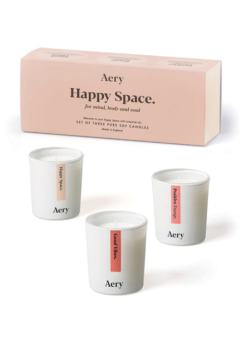 Pink Happiness gift set of three candles by Aery displayed next to product packaging on white bacground 