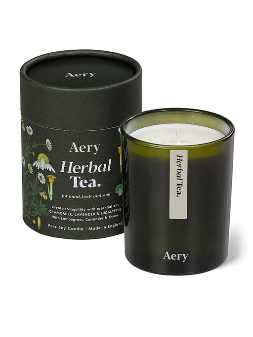 Green Herbal Tea candle by Aery displayed next to product packaging on white bacground 