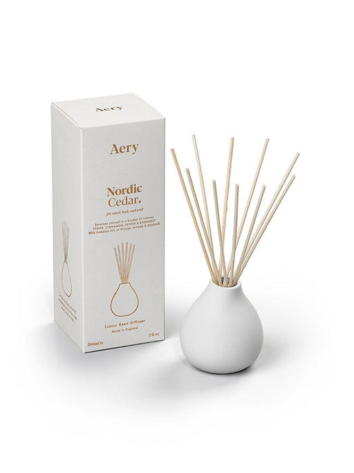 White Nordic Cedar diffuser by Aery displayed next to product packaging on white bacground 