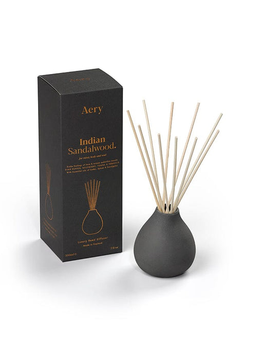 Black Indian Sandalwood diffuser by Aery displayed next to product packaging on white bacground 