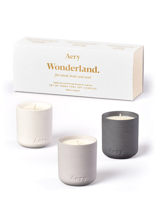 White Wonderland gift set of three mini candles by Aery displayed next to product packaging on white bacground 