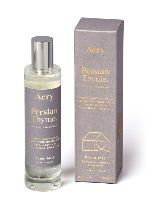 Grey Persian Thyme room mist by aery displayed next to product packaging on white bacground 