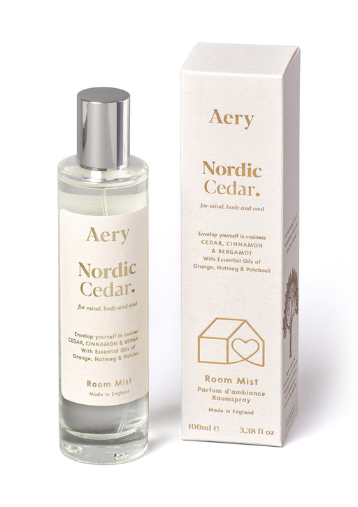White Nordic Cedar room mist by Aery displayed next to product packaging on white bacground 