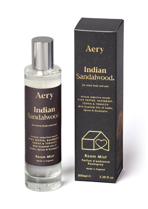 Black Indian Sandalwood room mist by Aery displayed next to product packaging on white bacground 
