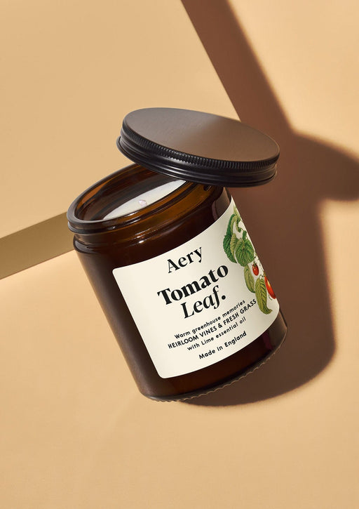 Tomato leaf jar candle by Aery displayed on cream bacground 