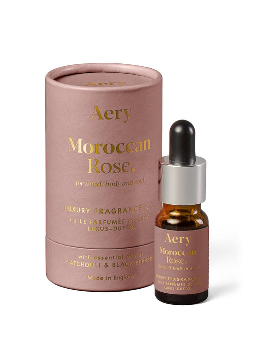 Aubergine Moroccan Rose fragrance oil by Aery displayed next to product packaging on white bacground 