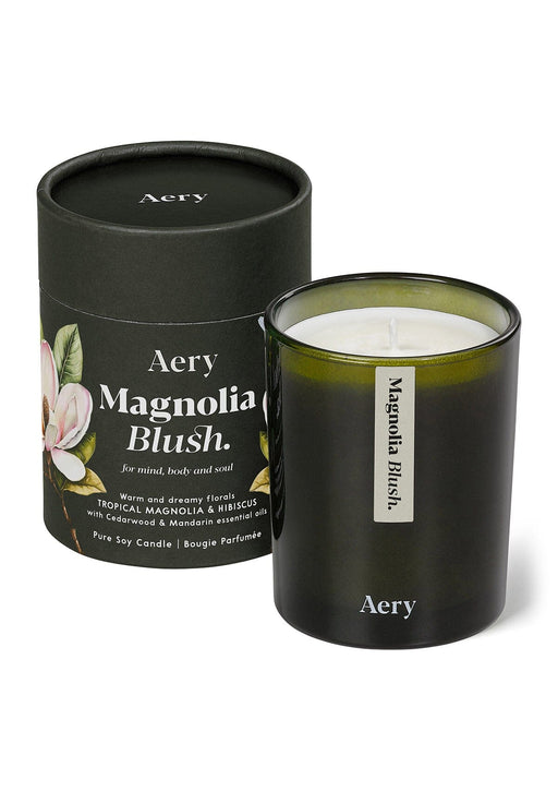 Magnolia Blush candle by Aery displayed next to product packaging on white bacground 