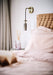 Lilac Dream Catcher pillow mist by Aery displayed next to Dream Catcher reed diffuser sat on bedside table 