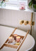 Wanderlust Giftset of three candles by aery displayed on wooden bath tray placed over bath  